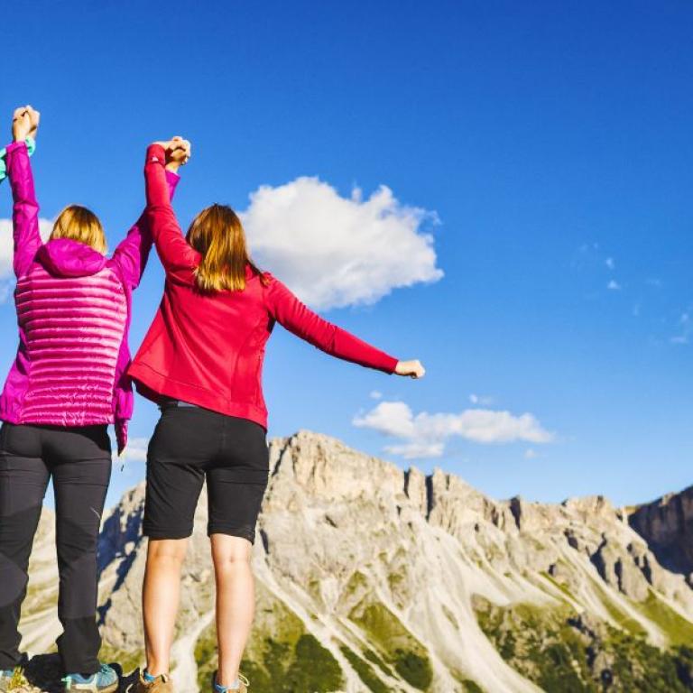A group of happy women hiking under the blue sky