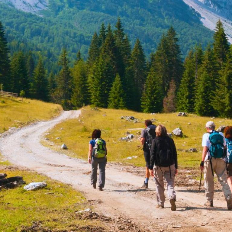 A small group walking on a trail in the Dolomites