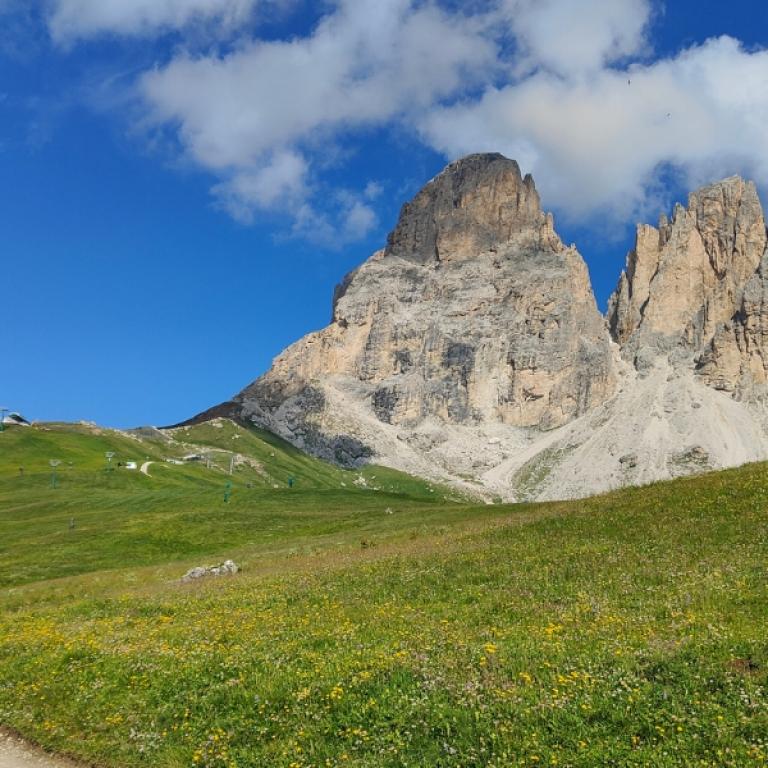 Self-guided Italy walking holiday in the mountains with alpine meadow and rocky peaks