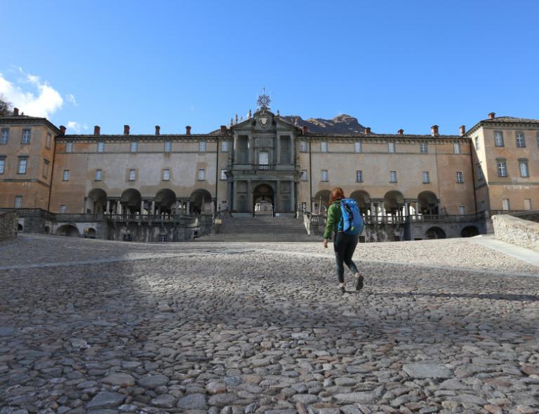 Cammini in Italia woman on camino de oropa with sanctuary