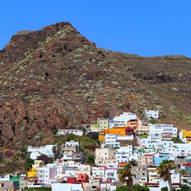 Colorful hillside village in Tenerife seen during walking holidays in Spain between mountains and sea