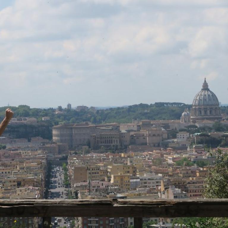 hiker celebrating arrival in Rome at the end of Via Francigena Viterbo to Rome Pilgrimage