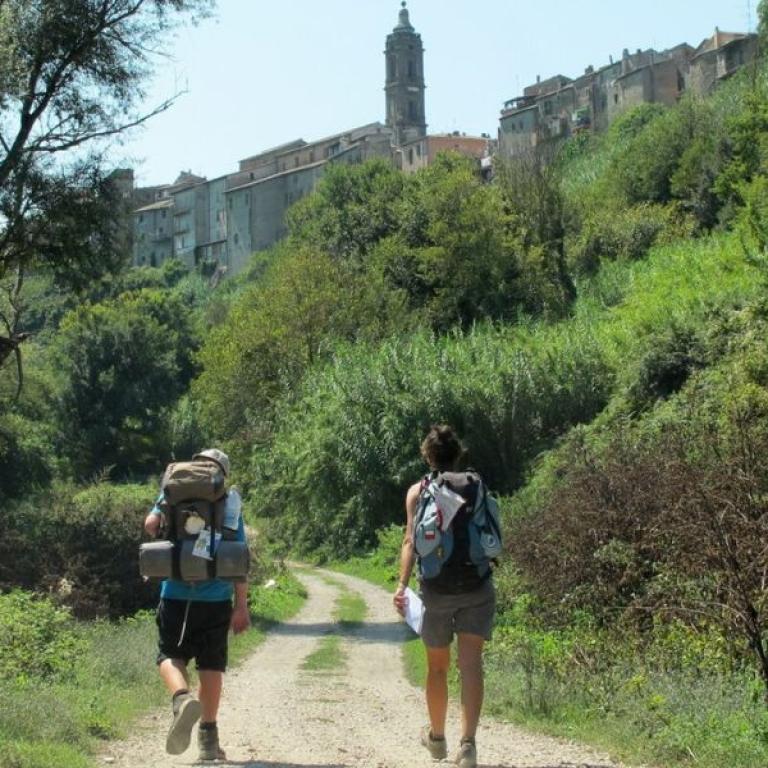 hikers entering Campagnano on Via Francigena