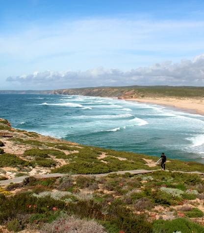 surfer walking with seaside view of Algarve