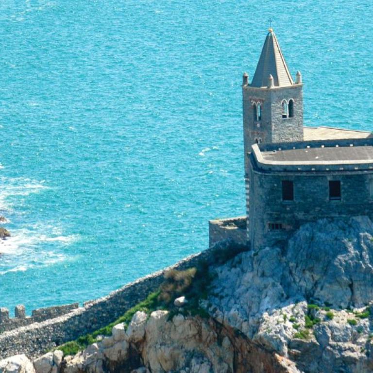 Stone church of San Pietro perched on the cliffs of Porto Venere above the deep blue Mediterranean Sea