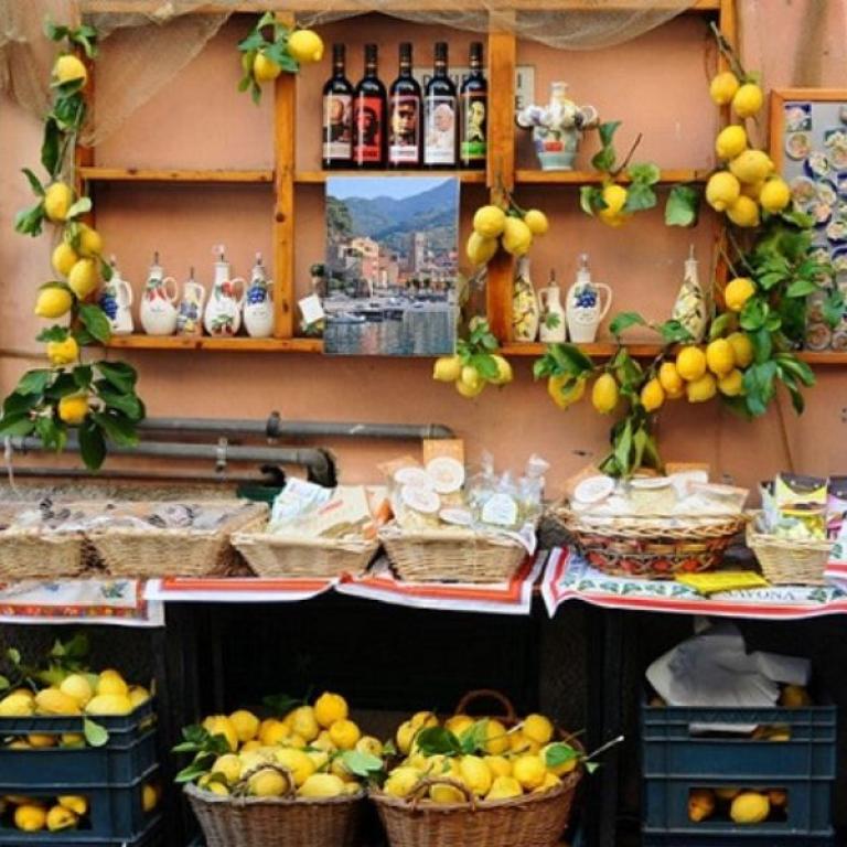Local shop display with lemons, ceramics and traditional products in a Cinque Terre village