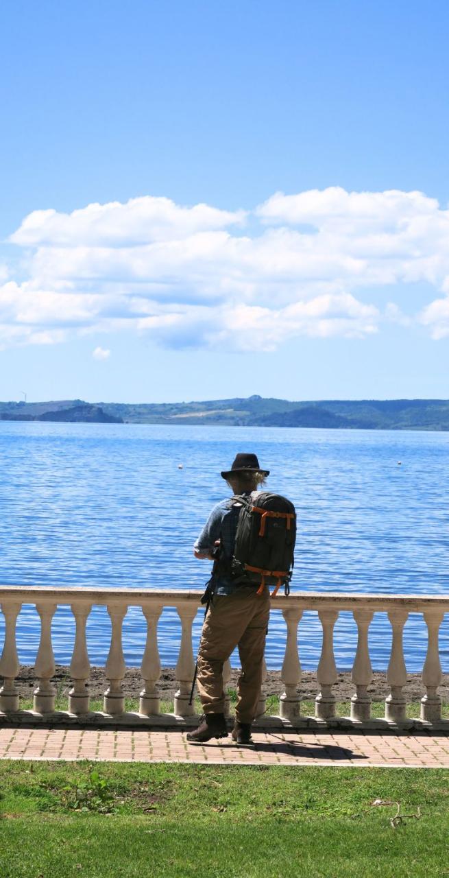 man admiring the bolsena lake during via francigena 