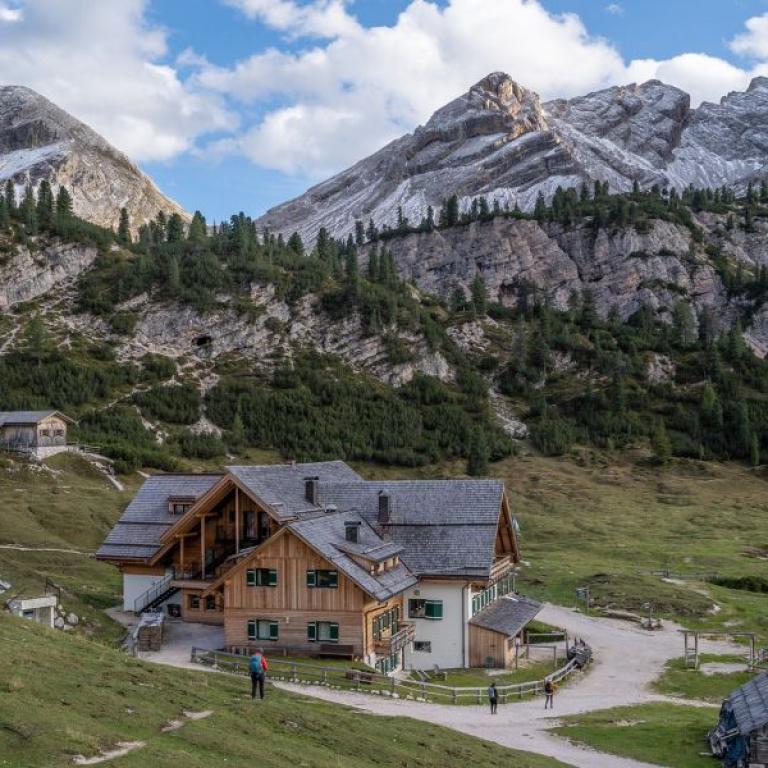 hut surrounded by the dolomites