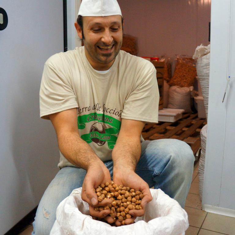 Local producer showing Piedmont hazelnuts, a delicious stop along the barolo walking trails.