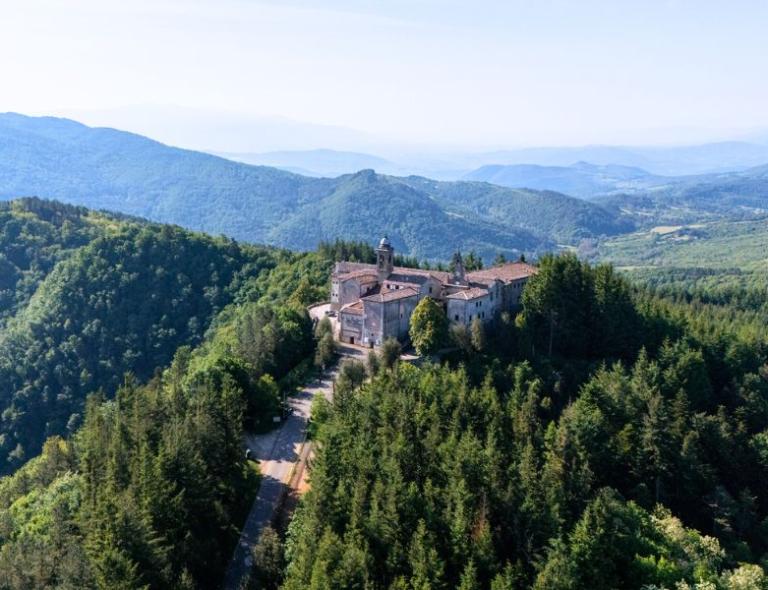 Mountain monastery surrounded by forests along the Via degli Dei trail