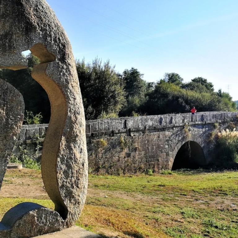 Puente Sampayo on the Camino Portuguese with houses in background