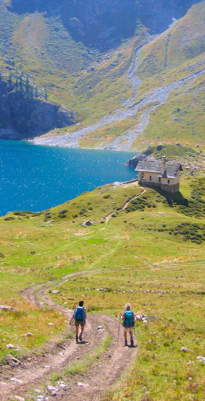 A man walks atop mountains on the Via Francigena