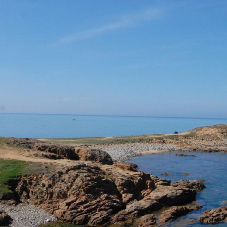 Rocky shoreline and transparent waters along one of Sardinia’s most scenic coastal walking routes