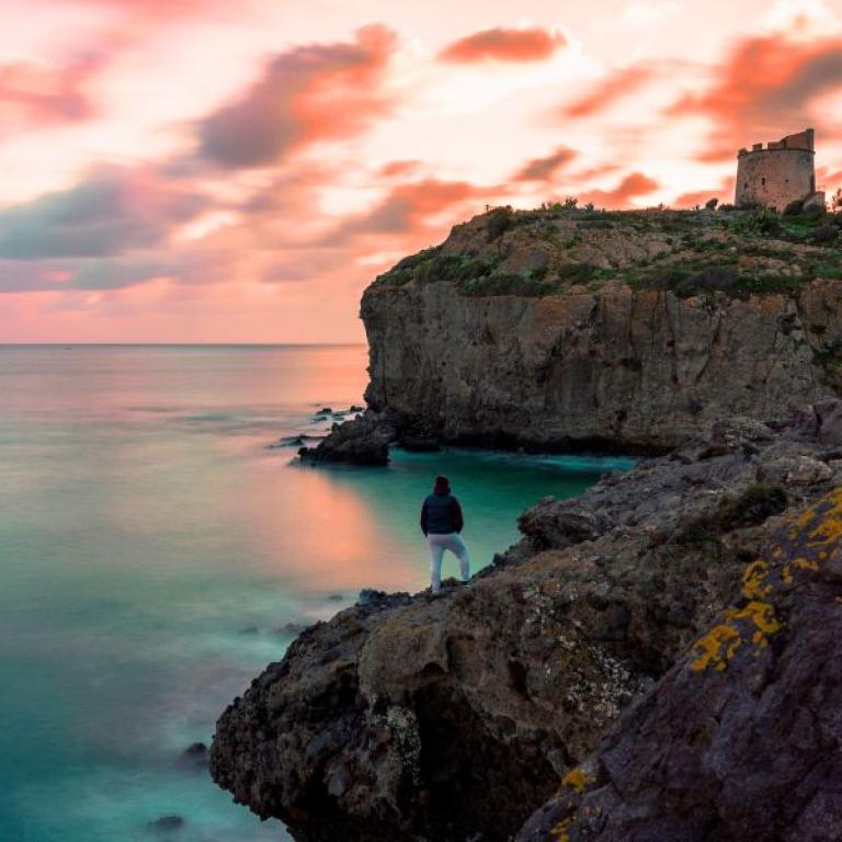 sunset in torre canai sant'antioco seen from a coastal path, perfect for hiking in Sardinia