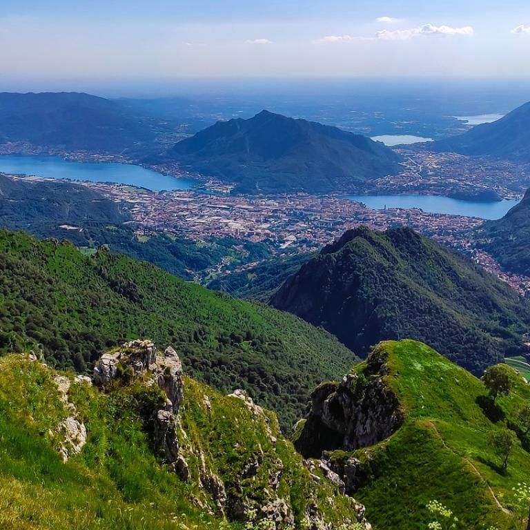 Panoramic view from the mountains above Lecco, overlooking Lake Como and the Italian Lakes from a hiking trail.