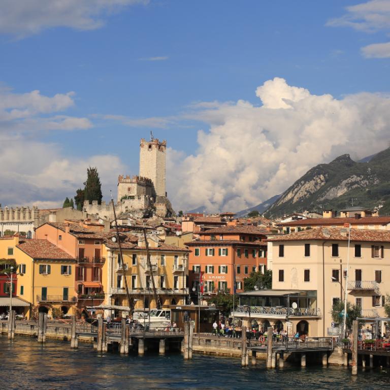 Malcesine castle rising above the lake and mountains, along scenic Italian Lakes hiking routes