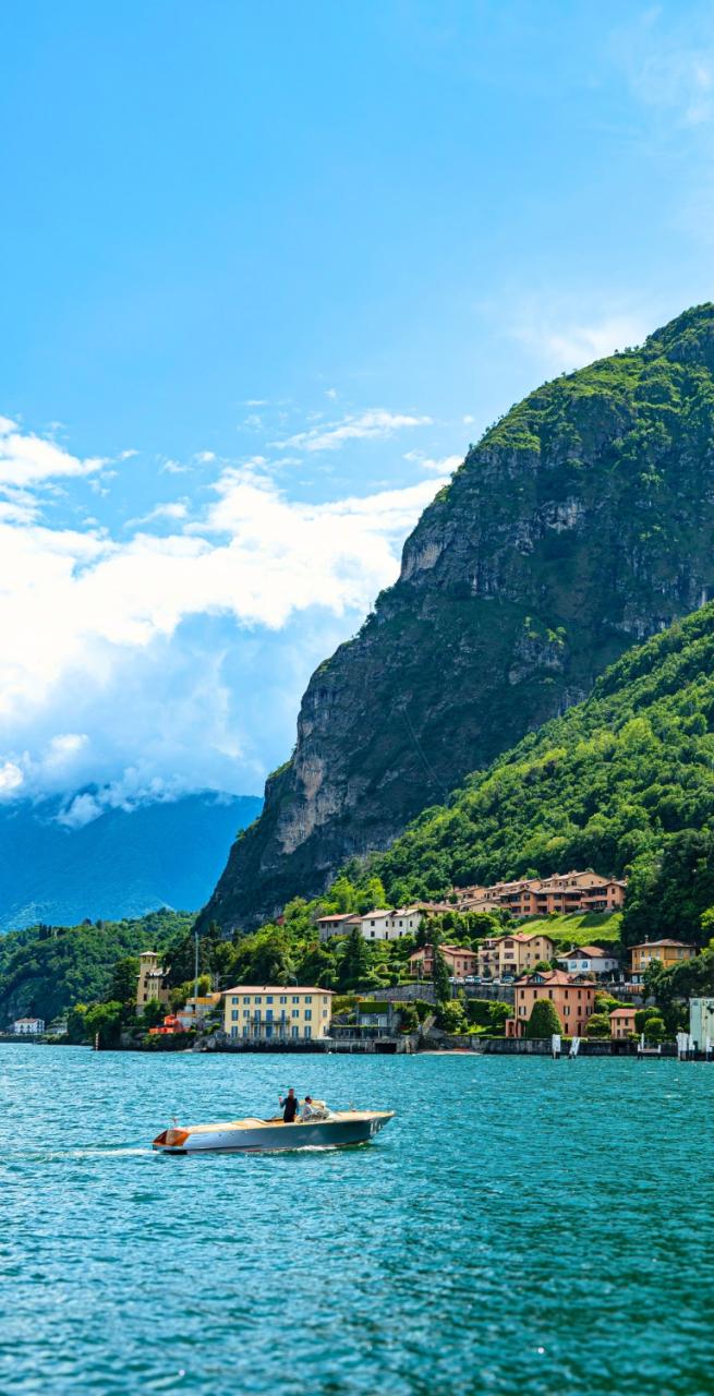 Colorful lakeside town of Cernobbio with mountains in the background, along a scenic hiking Lake Como route