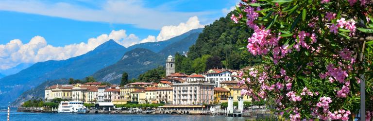 Colorful lakeside town of Cernobbio with mountains in the background, along a scenic hiking Lake Como route