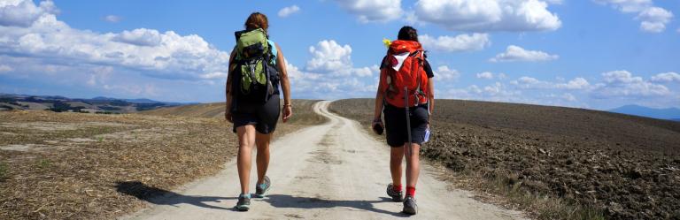 backpacking trips couple walkers on francigena path