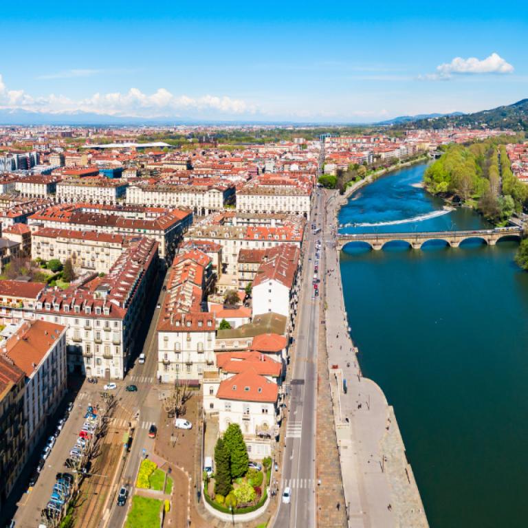 Aerial view of Turin with the Po River, a bridge and the Mole Antonelliana along the Val di Susa trek.