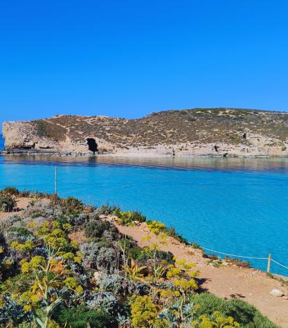 walking towards the pristine sea of malta